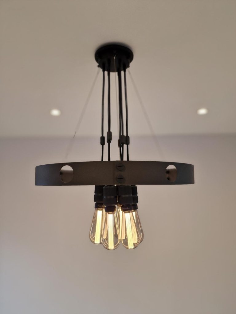 Modern pendant light fixture with exposed filament bulbs installed by J2 Build’s electrical team